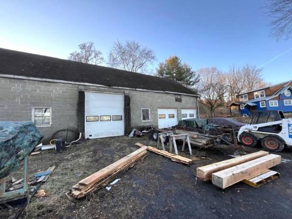 Construction materials next to detached garage at 763 County Route 1 in Pine Island.