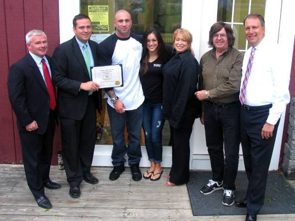 Photo by Roger Gavan County Executive Steve Neuhaus presented Patrick Gonzales with a certificate of recognition for his entrepreneurial spirit.That same day Jim Mezzetti of Myles Financial Services awardded Gonzales with a membership in the Warwick Valley Chamber of Commerce. From left, Jim Mezzetti, Orange County Executive Steve Neuhaus, Moore Dairy owner Patrick Gonzales and General Manager Grazia Iodice, WTBQ Station Manager Taylor Sterling, station owner Frank Truatt and Orange County District Attorney David Hoovler.
