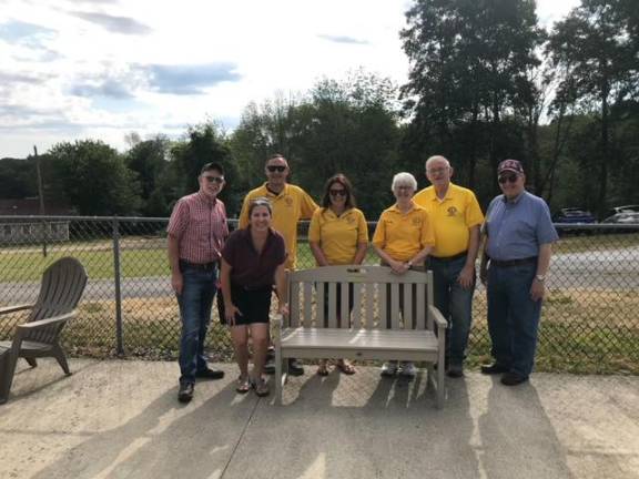 Celebrating the new bench made by Trex recyclers were left to right: Town Supervisor Michael Sweeton, Recreation Director Samantha Walter, Warwick Lions Michael Andersen, Erin Andersen, Kathy McManus and George McManus, Town Councilman Floyd De’Angelo