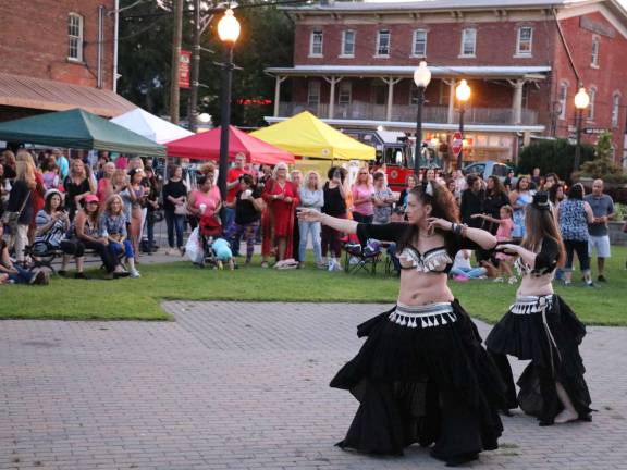 The crowd enjoys a demonstration of belly dancing.