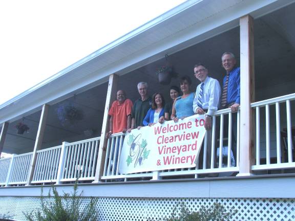 From left, Warwick Valley Chamber of Commerce Board member Wayne Patterson, Clearview Vineyard owners Frank and Karen Graessle, staff member Hannah Tucker, Chamber President Sherry Bukovcan, Town of Warwick Supervisor Michael Sweeton and Chamber Executive Director Michael Johndrow celebrate the first anniversary of Clearview's tasting facility.