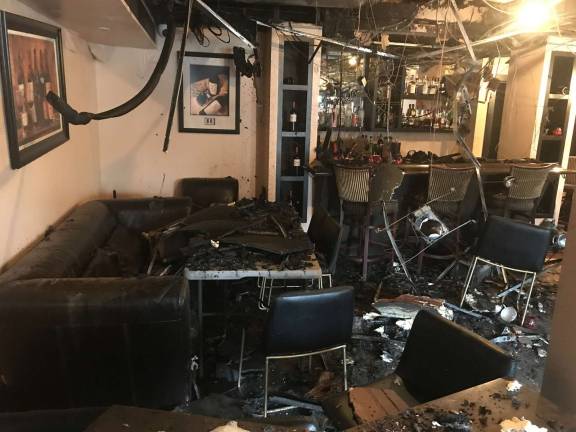 According to building owner Tony Sylaj, the fire, believed to be caused by faulty electrical wiring inside the walls, originated in the former location of La Piazza at 24 Railroad Ave.