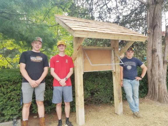 Left to right: Jared Verblaauw, Sean Mitchell and Corbett Schultz with the new kiosk.