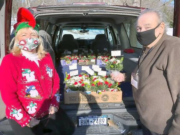 Mary Pohlman and Robert Caffrey, Monday Captain, distribute flower arrangements to Meals on Wheels of Warwick clients. Photos provided by Debby Briller.