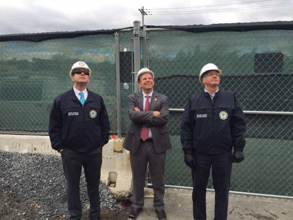 County Executive Steve Neuhaus, Commissioner of Public Works Chris Viebrock and Deputy County Executive Wayne Booth watch as the last steel beam is raised to the upper floor in the new Division Two (Photo provided)