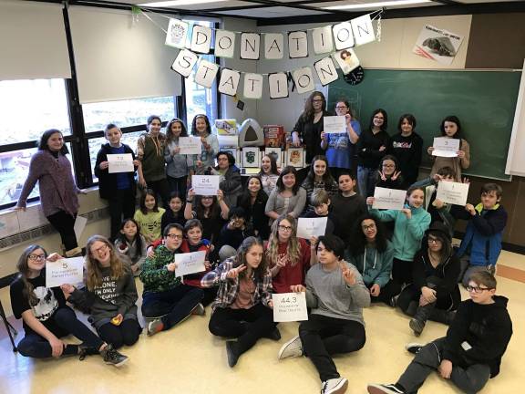 Photo by Kayla Glander Members of the Warwick Valley Middle School's Dumbeldore's Army club recently collected 72 cans of cat food, more than 44 pounds of dog treats and 40 miscellaneous items to give to "our non-human friends." The Drive that brought in donations for the humane society was inspired by the character Hermoine, who feels that the magical creatures called House Elves are not treated with respect, simply because they are non-human. She begins an organization called the Society for the Promotion of Elfish Welfare in order to bring awareness to their treatment.