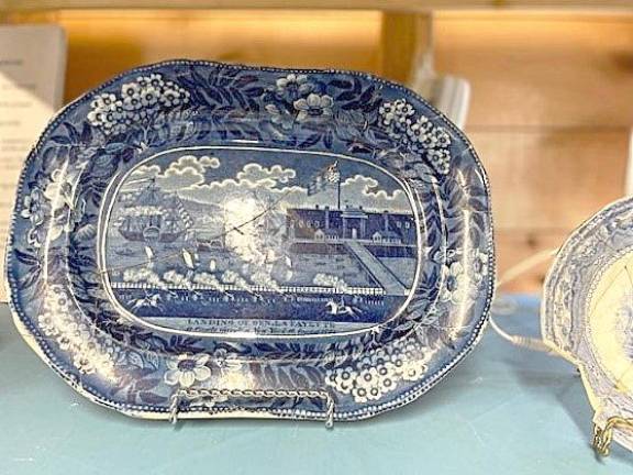 The blue plate was found in four pieces in the privy. Lafayette came to visit in 1885 and the state of New York gave him a parade and the plate was given to him.