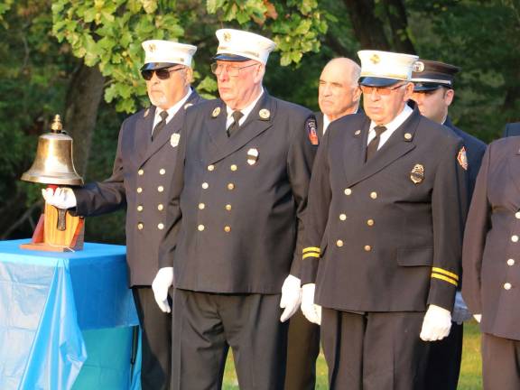 Everyone stood silently, heads bowed as Chief Brasier read of the names of the local residents who perished in the attacks. Past Chief Frank Fotino (far left) struck a ceremonial bell for each victim.