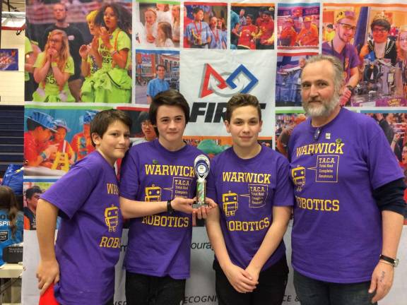 Provided photo Pictured from left to right at the awards ceremony, members of the Warwick Robotics Team are Sawyer Masefield, Kalen Luraschi, Aiden Woods and Coach Paul Woods.