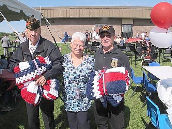 Raffle winners of the crocheted blankets were Everest LeMay, left, and Joe Olivieri, right, presented by Millie Rivera, center.