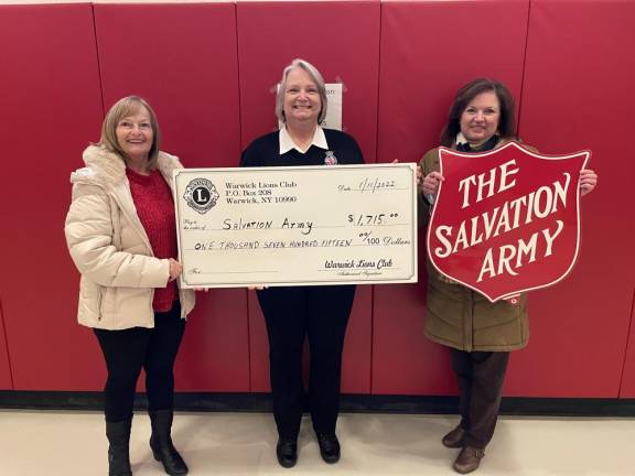 Lions Club Chairperson Carol Buchanan and President Christine Adams present a check for $1,715.00 to Mary Moore of the Salvation Army.