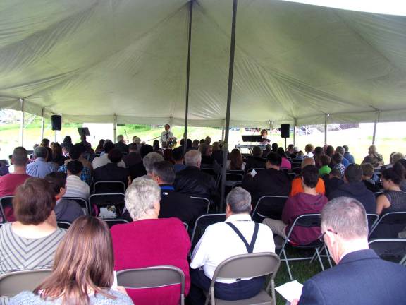 Photos by Roger Gavan Deacon Tim Montgomery welcomes guests to the ground-breaking service held on the site of new Ministry Center behind the church facility at 5 Wisner Road.
