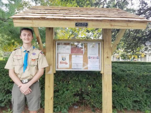 Sean Mitchell with his Eagle Scout project, now in use for Warwick Historical Society