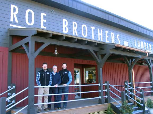 Photo by Roger Gavan Arnold Bieling (center) flanked by his sons and co-owners Tim (left) and Scott (right) outside Roe Brothers Lumber in the Village of Florida. The company is celebrating its 130th year of doing business.
