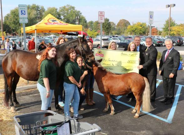 Photo by Roger GavanWarwick ShopRite Store Manager Charlie Sladek (center), joined by Company President Brat Wing (right) and District Manager Rich Martin (left) presented a symbolic check for $4000 to the Amity Foundation for Healing with Horses.