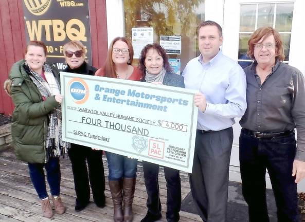 Pictured from left to right are: Lorraine Steadman of Orange County Motorsports Entertainment, WTBQ Manager Taylor Sterling, Amy Smith of OCME, Suzyn Barron, president of the Warwick Valley Humane Society, Orange County Executive Steve Neuhaus and WTBQ owner Frank Truatt.
