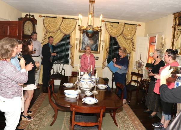 Warwick Historical Society Executive Director Nora Gurich (rear center right) directed that presentation of the dishes to be on loan in the Hathorn House Museum Room. Sue Gardner (rear center left), secretary of Friends of Hathorn House, an organization formed to preserve the historic home, accepted the dishes on behalf of the new owners, who were away at that time.