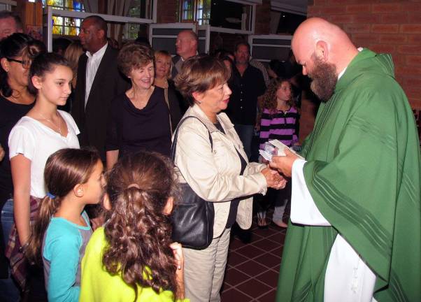 Photos by Roger Gavan After Mass, parishioners lined up to bid farewell to Father Micciulla.