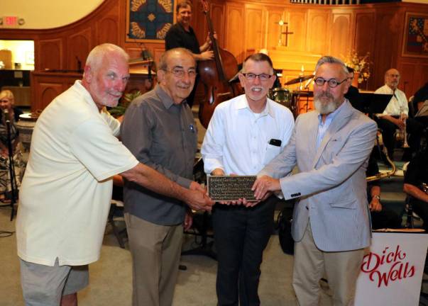 Some of Wells&#x2019; closest friends, from left, former Village Trustee Bill Iurato, who organizes the Summer Concert Series, Leo Kaytes Sr., Town of Warwick Supervisor Michael Sweeton and Mayor Michael Newhard, were on hand to pay tribute and present a bronze plaque in his honor that will be placed in Railroad Green.