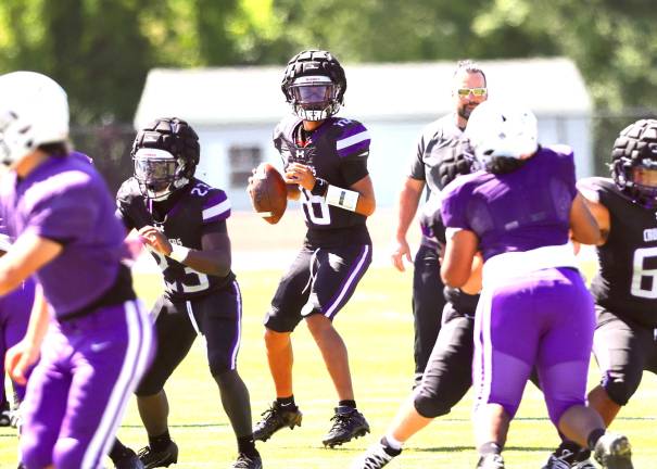 Crusader QB #18, Ethan Maldonado, looks for open receiver as the Crusaders work against the Wildcats.