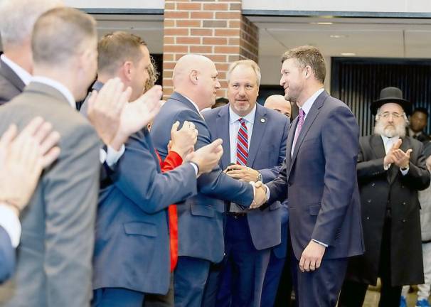 U.S. Pat Ryan shakes hands with Orange County Sheriff Paul Arteta following his inauguration at the U.S. Military Academy. The sheriff is flanked by Orange County Executive Stephen Newhaus, left, and Orange County District Attorney David M. Hoovler among other county and local officials.