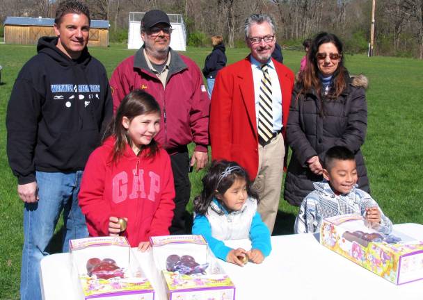 The golden eggs were successfully retrieved by Danielle Berry, 8, Kristina Correa, 3, and Oliver Portugal, 6. Standing from left, Ron Introini, Warwick Recreational Director, Joe Ceranolo, president of the Warwick Fire Department, Mayor Michael Newhard and Jo-Anne Dobbins, president of the WFD Ladies Auxiliary.