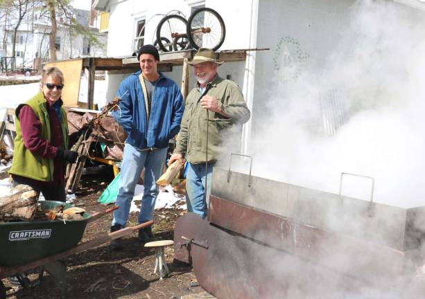 Photo by Roger Gavan Pat Gallagher (far right) enjoys a helping hand in making maple syrup from his sister Jane Gallagher-Felix and her son Liam, who had traveled from their home in Kailua on the island of Oahu in Hawaii.