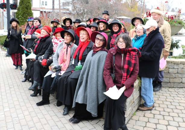 Photos by Roger Gavan To get everyone in the holiday spirit the Warwick Valley Chorale strolled along Main Street and Railroad Avenue, stopping at many of the shops and restaurants, singing Christmas carols.