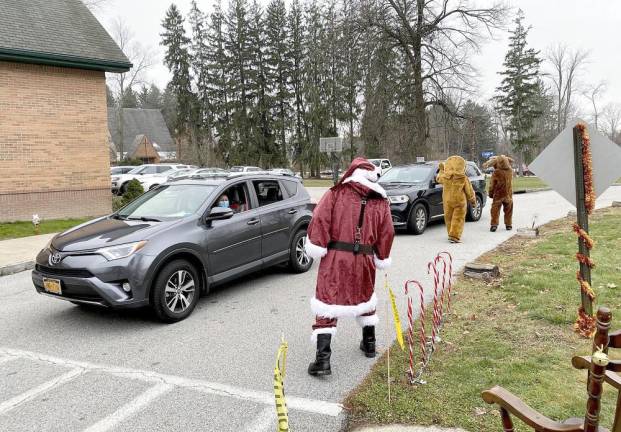 Santa, the Gingerbread Man and the Rudolf the red-nosed reindeer greet visitors at the ninth annual Breakfast with Santa. a drive-by event sponsored by the Warwick Valley Knights of Columbus held Dec. 12 at St. Stephen’s Parish.