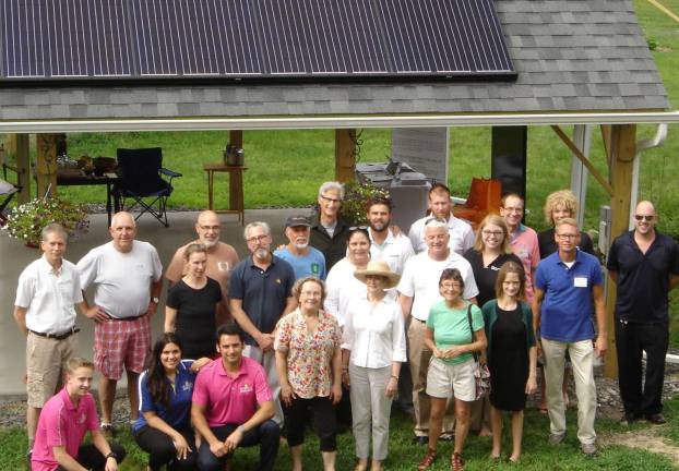 Photos provided by Mary Makofske At the Solarize Warwick launch July 8, homeowners, solar installers, and Sustainable Warwick and Solarize Hudson/Sustainable Hudson Valley members pose in front of a pavillion holding new solar panels. On the left is Michael Helme, the homeowner, next to Tom Woglom, who built the pavilion, Sustainable Warwick chair Geoff Howard, and Warwick Mayor Michael Newhard.