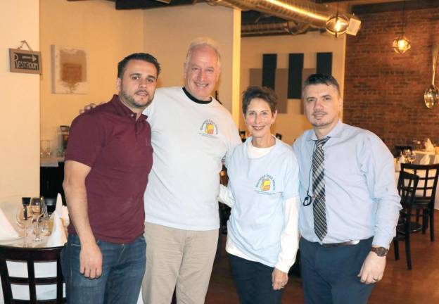 Backpack Snack Attack volunteers Len Singer and Arlene Neiman helped plan the event with Grappa Ristorante owner Tony Sylaj, left, and business partner Nick Ahmetaj, right.