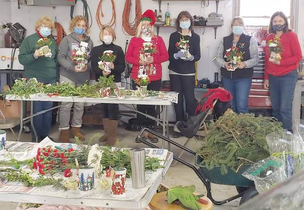 The Warwick Valley Gardeners Club putting together the flower arrangements. Pictured from left to right are: Ellen Nye, Ann Green, Kathryn Ives, Mary Pohlman, Mary Berrigan, Janice Ashe and Laurie Unick.