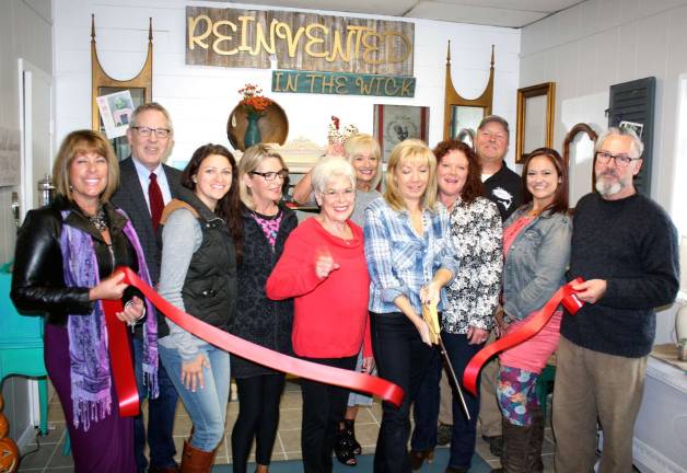 Photo provided by Bea Arner On Sept. 30, Mayor Michael Newhard (far right) and members of the Warwick Valley Chamber of Commerce joined Terri Clarke (center) and her friends to celebrate the grand opening of her new business, Reinvented in the Wick, with a ribbon cutting ceremony.