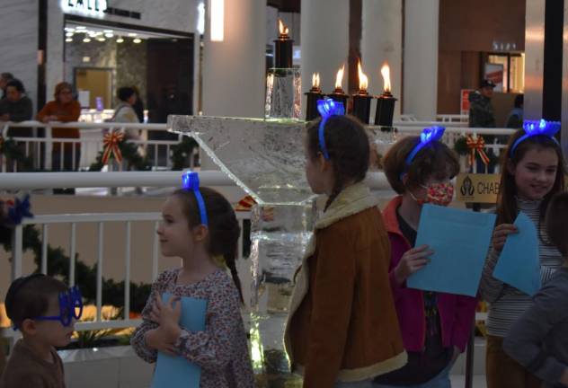 The ice menorah is lit, briefly and carefully.