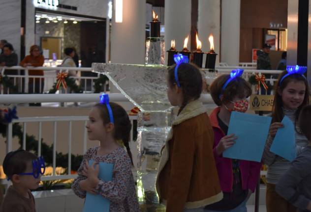 The ice menorah is lit, briefly and carefully.