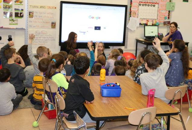 Photo by Roger Gavan Second grade students at Sanfordville Elementary School offer their suggestions to Play by Design representative Lisa DeShano.
