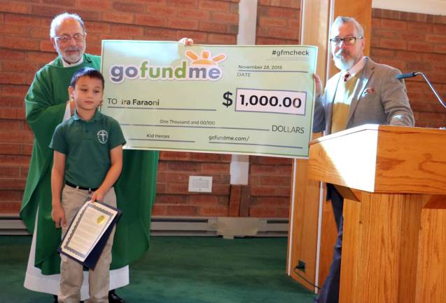 Photos by Roger Gavan On Wednesday, Nov. 29, after Mass at the Church of St. Stephen, the First Martyr, Village of Warwick Mayor Michael Newhard presented a Certificate of Recognition and a symbolic GoFundMe check of $1,000 to Ira Faraoni for his &quot;Ira's Helping Hands&quot; campaign. From left, Pastor Rev. Jack Arlotta, Ira Faraoni, 7 and Mayor Michael Newhard.