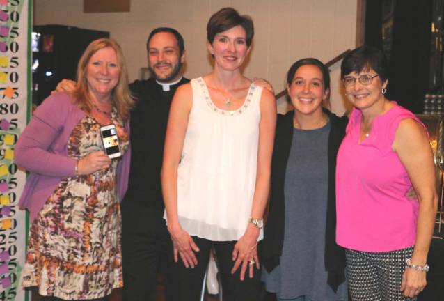 Photo by Roger GavanRepresentatives of the lucky moms pose with Parochial Vicar Rev. Richard Marrano and event Chair Mary Juliano. From left, Karen Reiber, Rev. Richard Marrano, Kelly O'Brien, Erin Reigan and Mary Juliano.