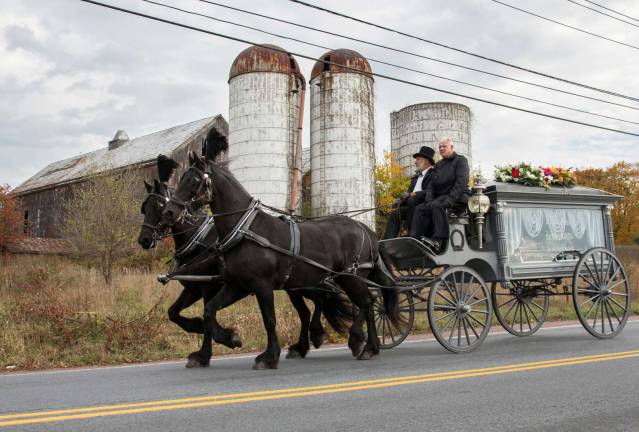Best of 2014: The horse-drawn hearse traveling along West Street near Pelton Crossing on the way to St. Stephen&#xfe;&#xc4;&#xf4;s Church in October. The journey fulfilled the wishes of Warwick resident Richard Katstra, who had passed away peacefully at home on Oct. 11. He was buried in the Warwick Cemetery. Photo by Robert G. Breese.
