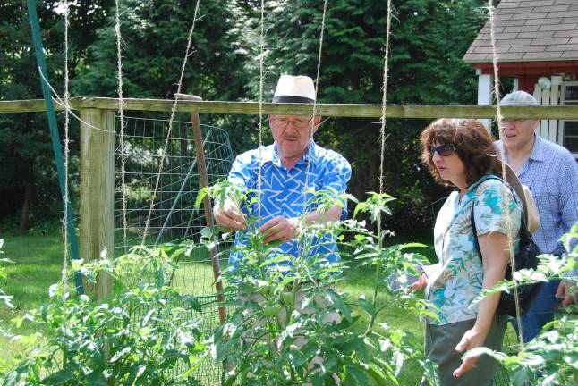 Klaas Vogel shows attendees his bustling veggie garden, featuring custom-made fencing, during a past Kitchen Garden Tour. Vogel is showing his garden again at this year’s event Aug 3.