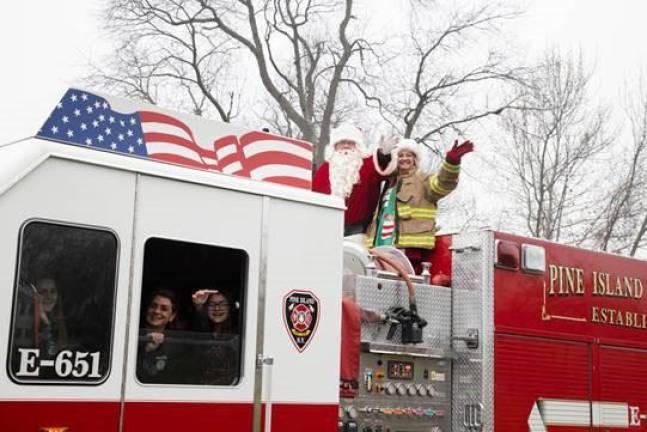 The Santapalooza Tour made its way through Pine Island Saturday with the Big Man’s entourage bolstered by the Pine Island Fire Department.