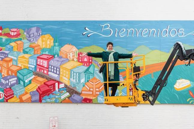 Muralist Grace Vazquez in front of her mural.