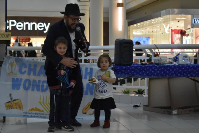 Rabbi Meir Borenstein of the Orange County Chabad with two of his children.