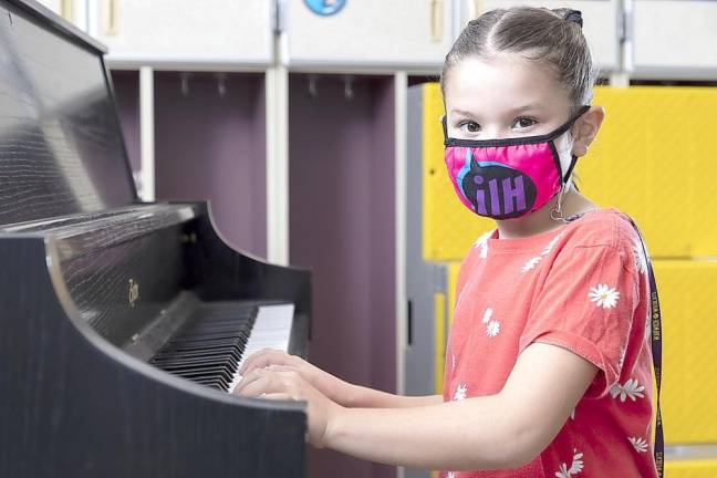 Park Avenue Elementary School second grader Molly Brady sits at the piano on Oct. 19, 2020. Photo by Tom Bushey/Warwick Valley School District.
