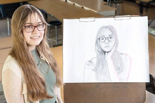 Warwick Valley High School senior Katerina Bucek poses with her artwork. Photo by Tom Bushey/WVSD.