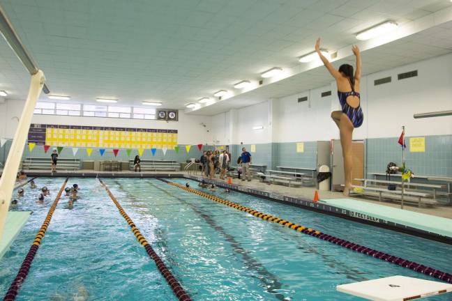 A varsity diver warms up before a meet in the district&#x2019;s newly renovated swimming pool.