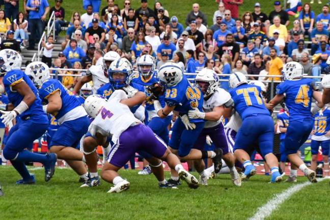 Warwick’s Jake Rooney and Anthony Marcano combine for a tackle in the first half of the Warwick vs Washingtonville football game on Saturday, October 28.