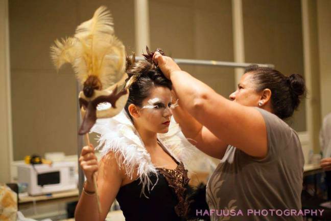 Vanessa Greeley helps her daughter, who modeled for her, get dressed in a chocolate dress Greeley created for a show.