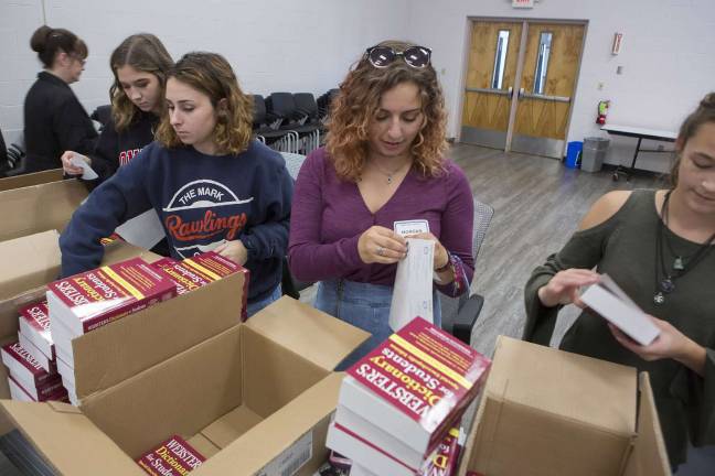 Photo provided by the WVSD Communications staff Members of the Warwick Valley School District&#x2019;s Interact Club ready dictionaries for the District&#x2019;s fourth graders.