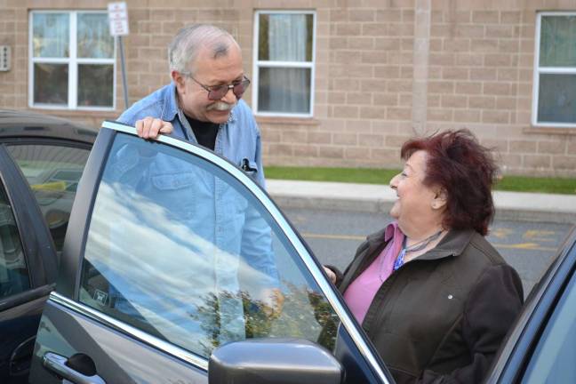 Provided photo A volunteer from the Friendly Visitor Program escorts a neighbor to the car for help in getting to a medical appointment - one of the most common services provided through the program.